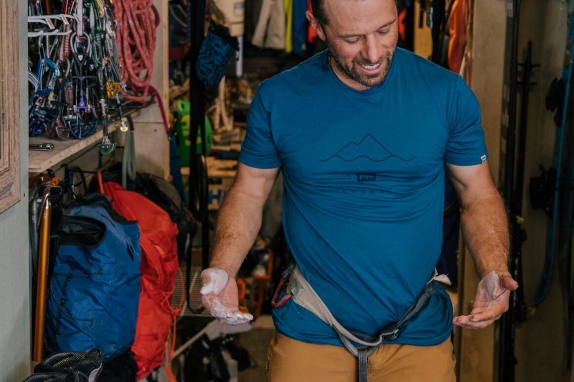 man in rock climbing gear excited