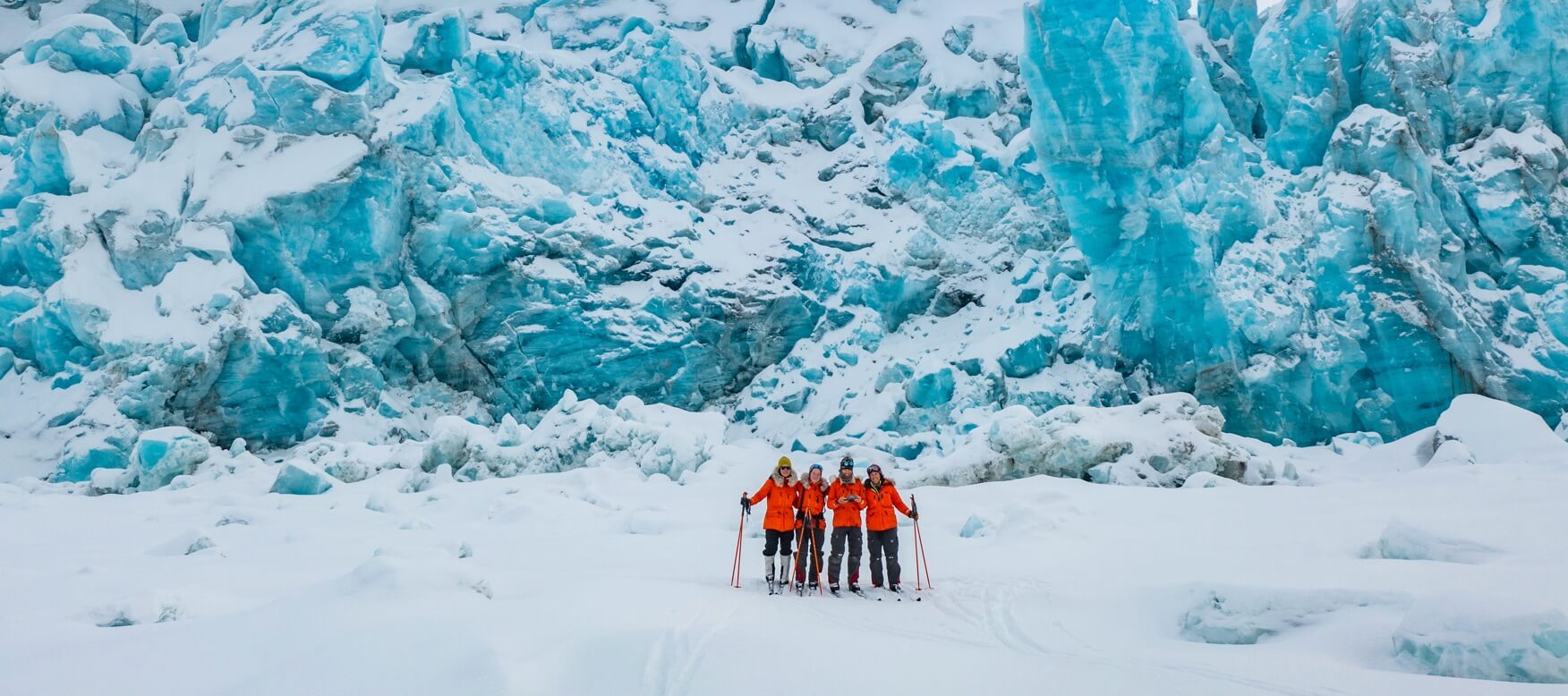 the scientists standing in front of a large glacier