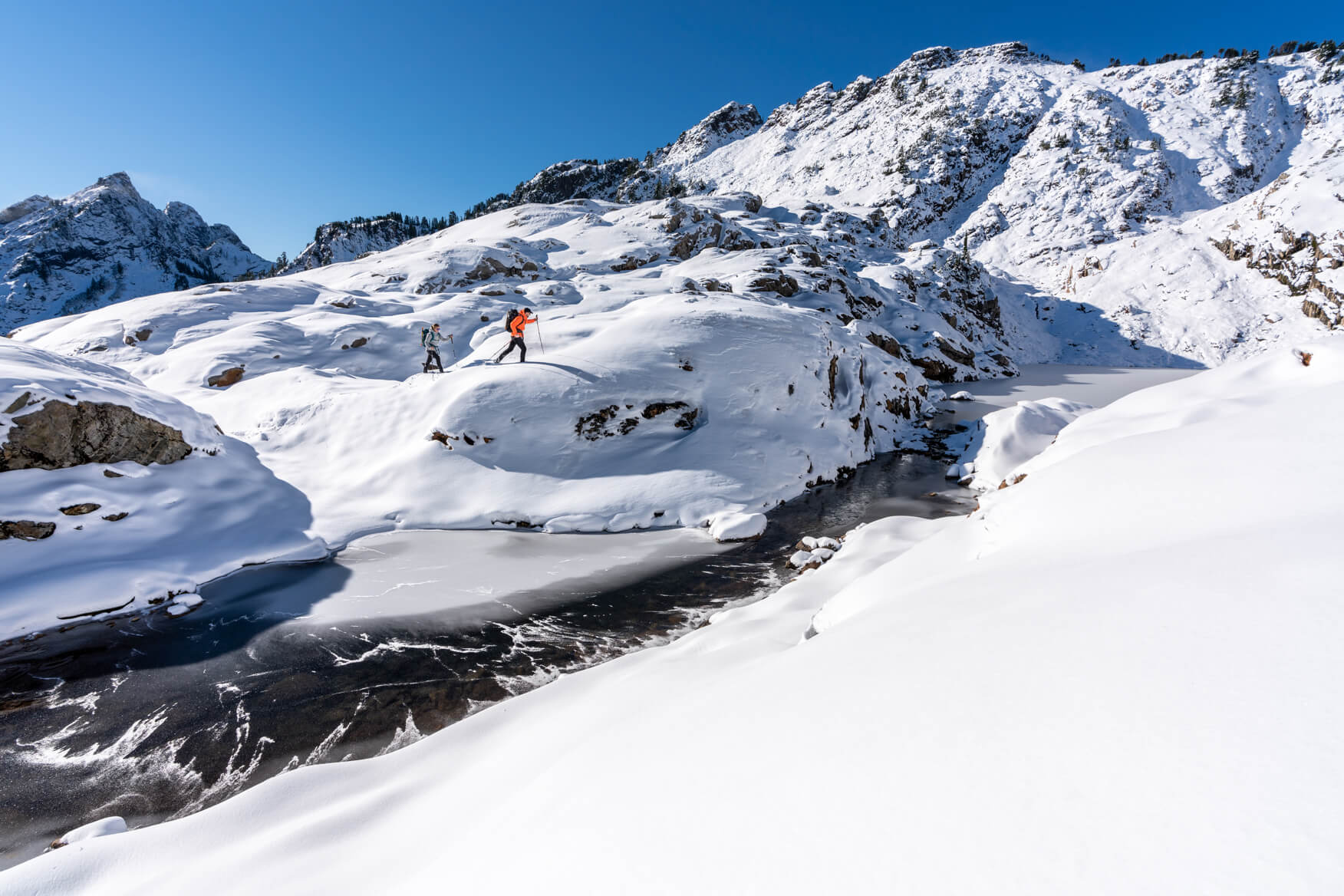 people hiking a snowy mountain