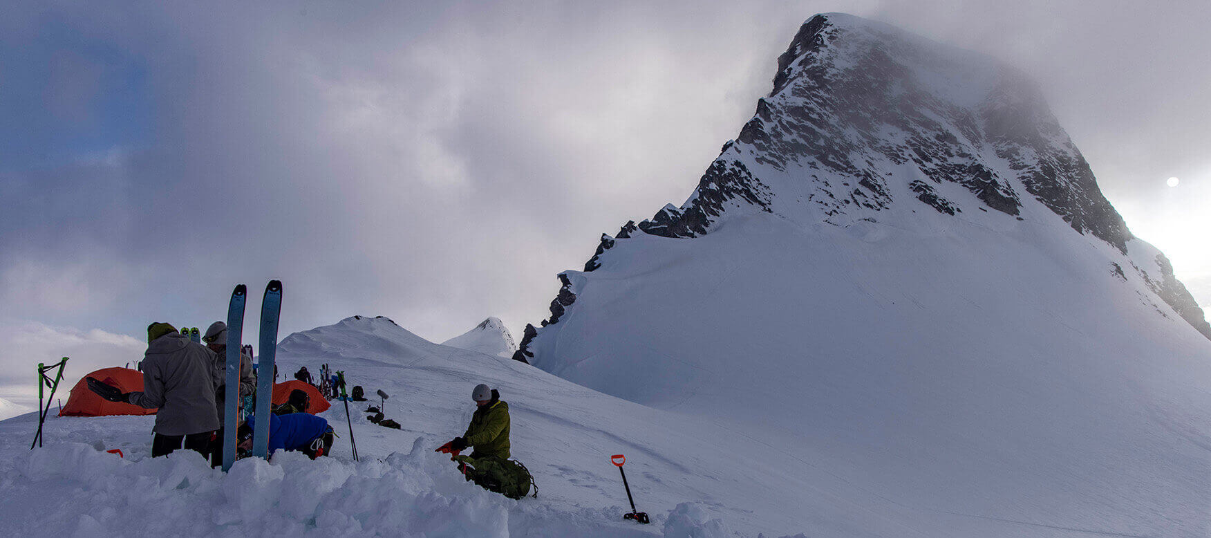 people camping on a snowy mountain