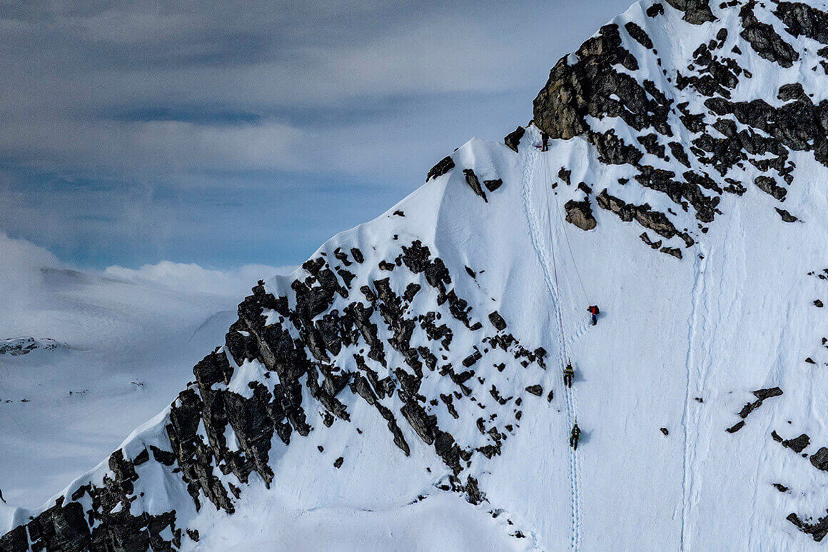 people climbing up a snowy mountain