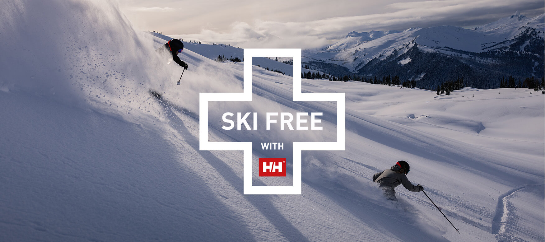 SKi Free logo on top of two skiers skiing powder.