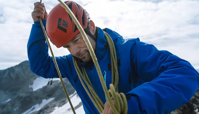 man climbing mountain in odin 9 worlds 2.0 jacket