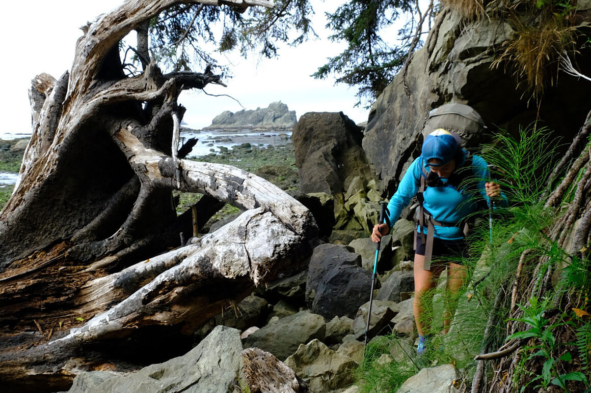 woman hiking along a coastline