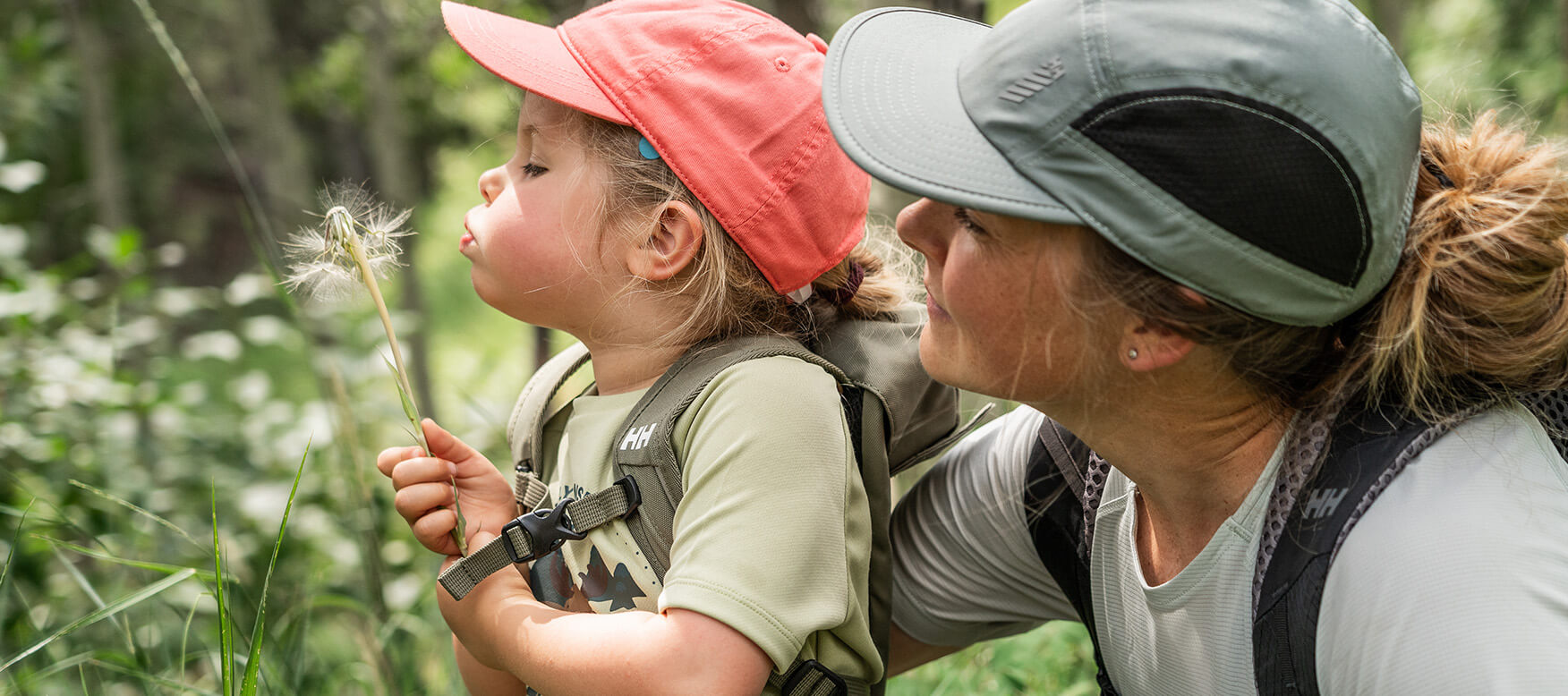mom and daughter looking at a flower