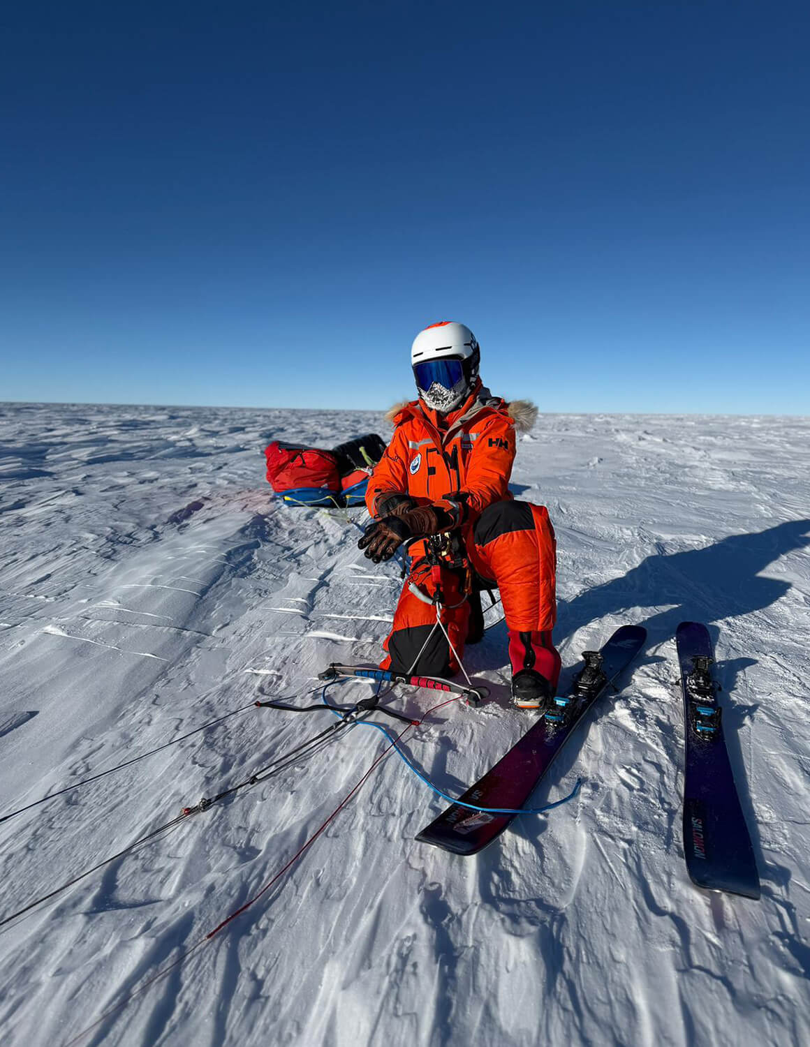 Glaciologist Heidi Sevestre standing by her skis in Antarctica