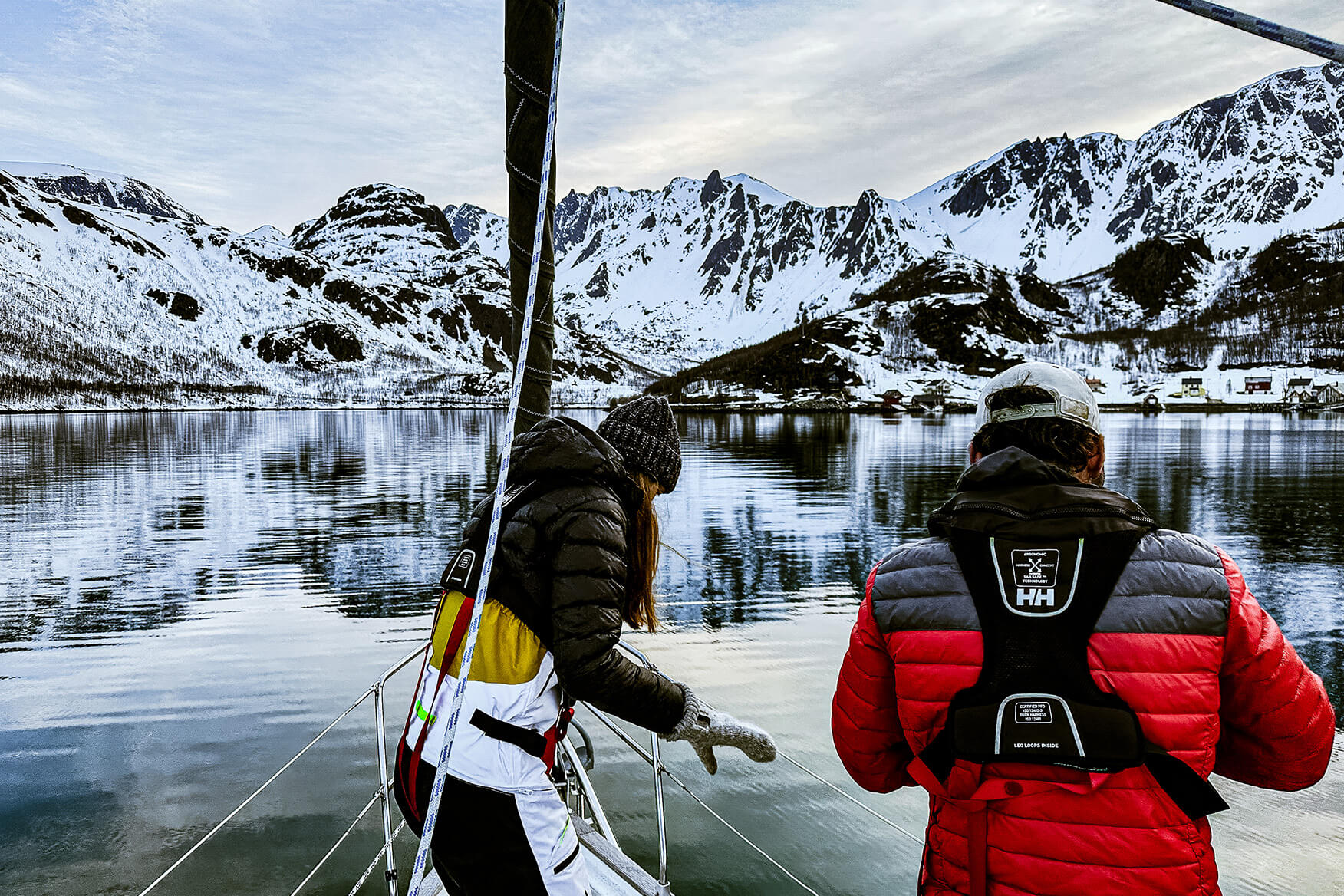 Getting ready to set anchor in Tverrfjorden, a side arm to Øksfjorden. two sailors getting ready to set anchor in a fjord in Finnmark