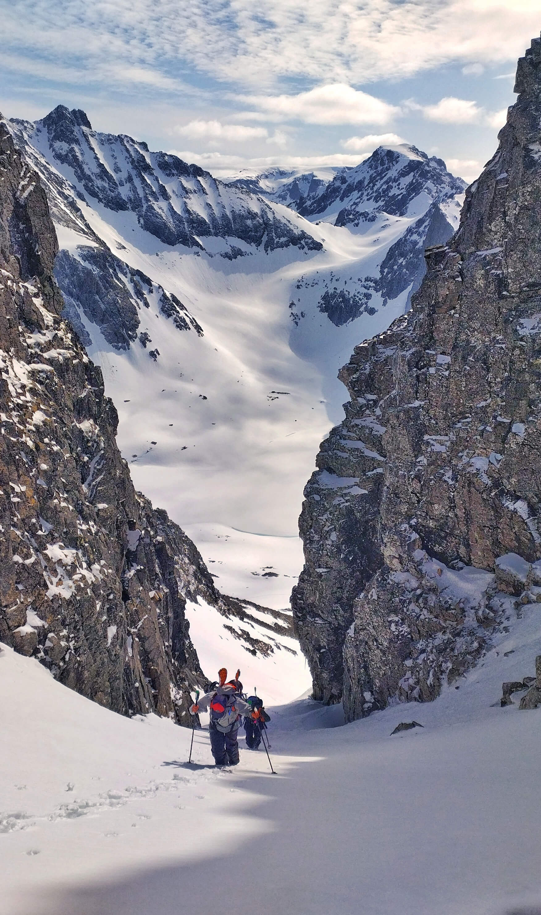 Kvænangstindan is a mountain range with wild, rugged peaks located in the Kvænangen municipality in Troms og Finnmark county. Spending a day here was a highlight of the trip. two skiers hiking up a couloir in Kvænangstindan