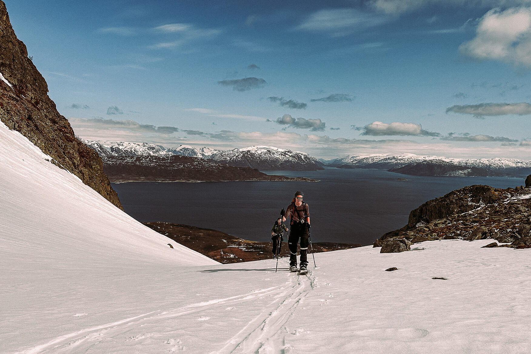 No dry powder in sight, but spring skiing still has it's perks. Just keep in mind that your temperature will vary a lot, based on weather, altitude, and activity level, and an inner layer of wool is a trusted companion throughout the day. two persons ski touring in Kvænangstindan