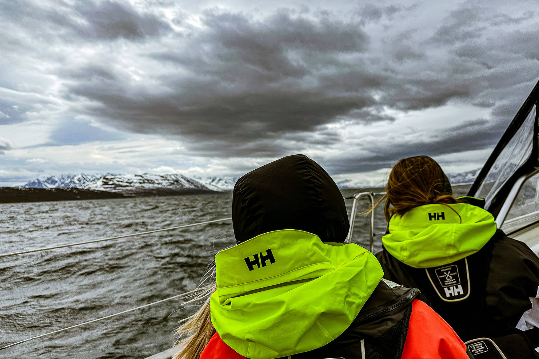 Make it a competition to pack as little as possible. When it's at its coldest, you'll have on all the layers you brought, and you don't need more garments than that. two sailors looking at the horison in Finnmark