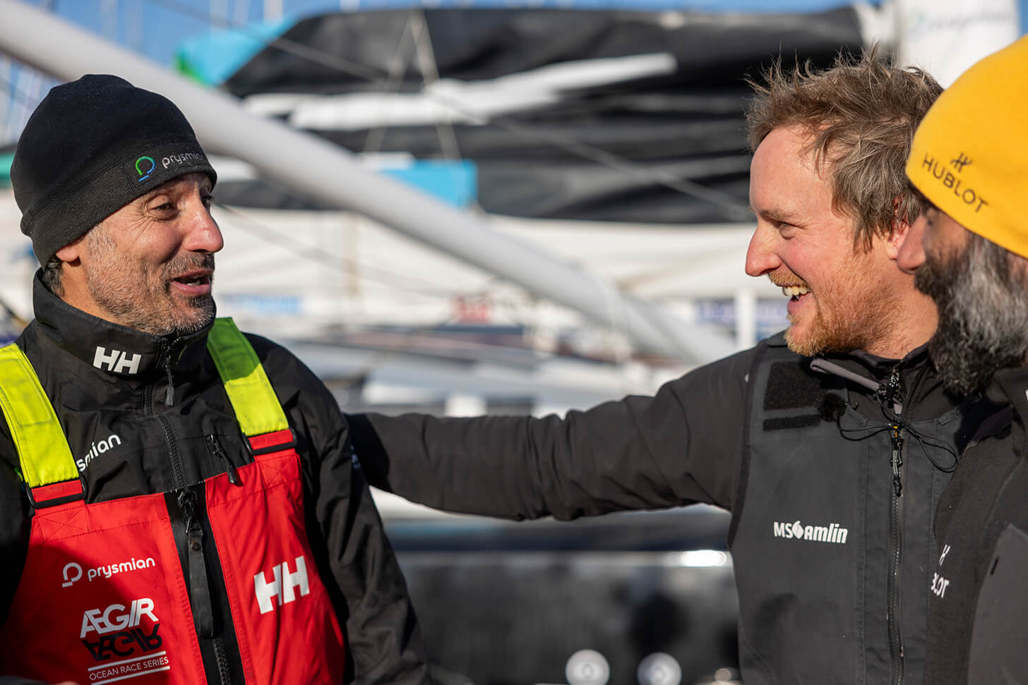 Three sailors on the dock after finishing the Vendee Globe