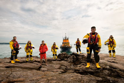 rnli team on the rocks in their gear