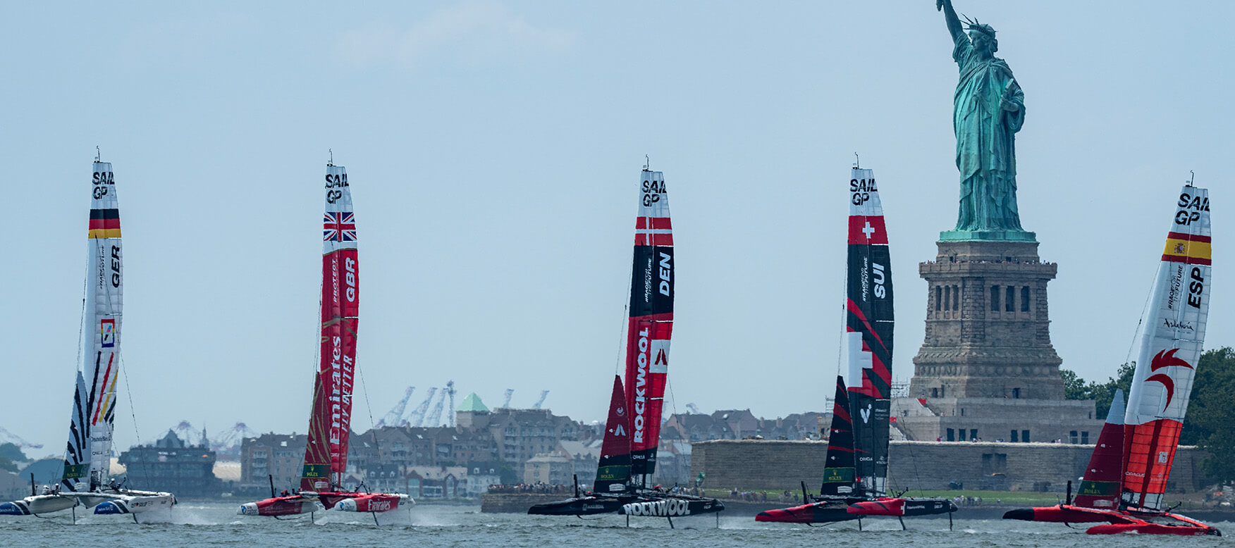 sailboats in front of the Statue of Liberty