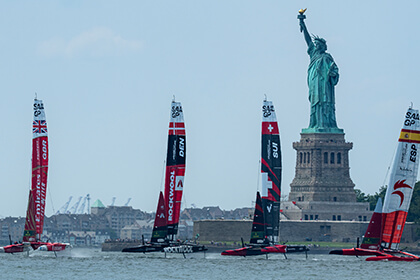 SailGP boats racing in front of the statue of liberty