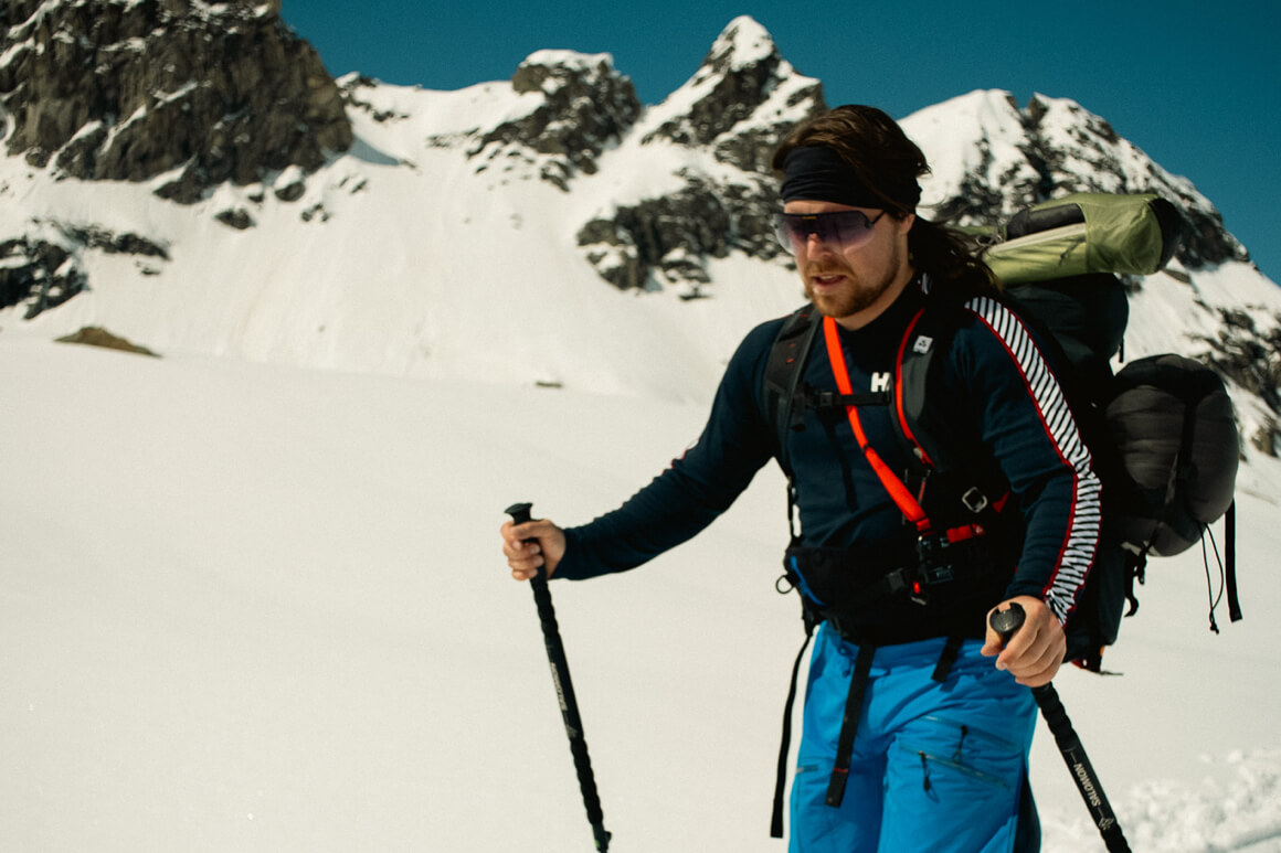paul de groot cross country skiing on a snowy mountain with a backpack on his back 