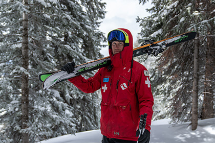 ski patroller holding his skis