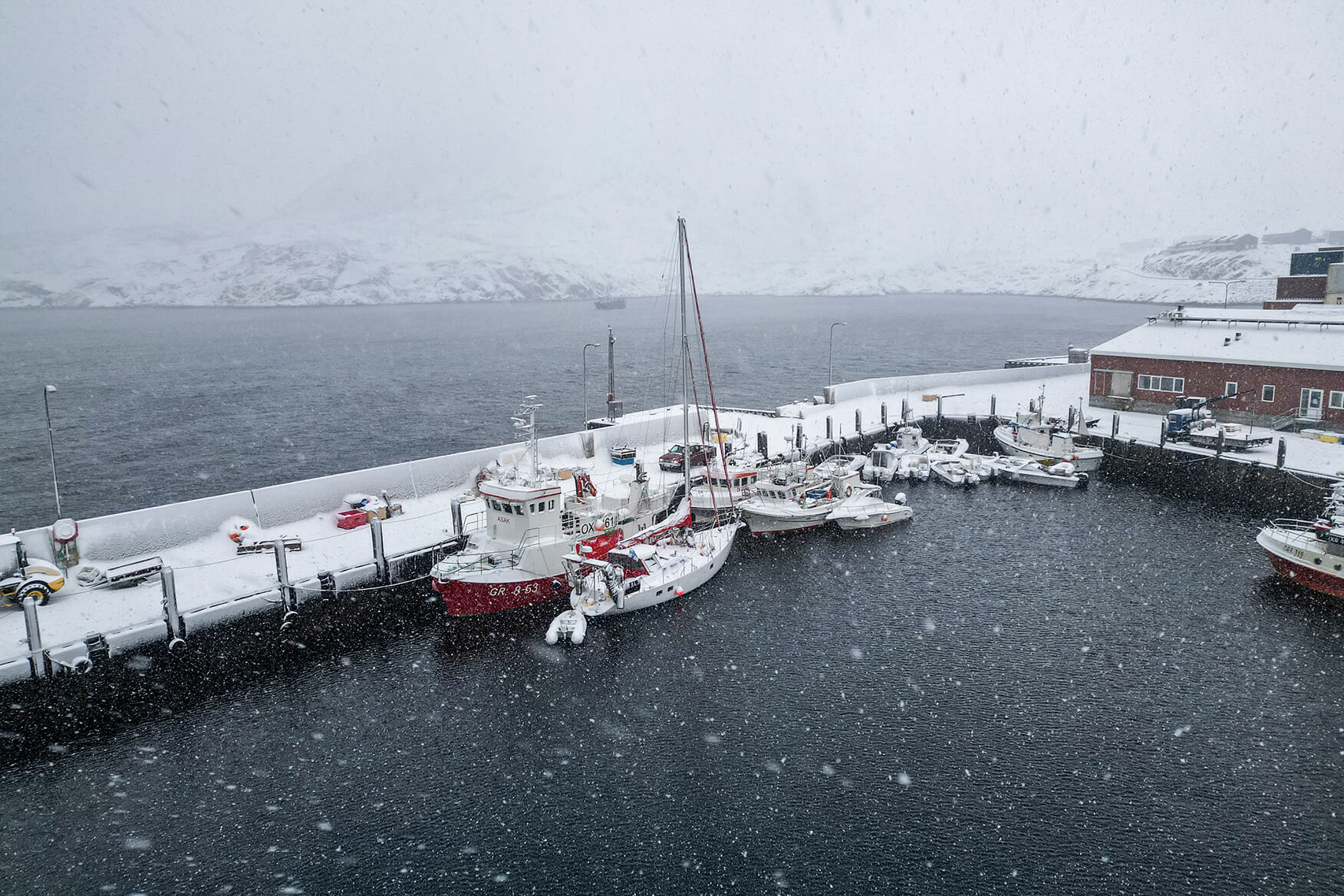 sailboat in a snowy marina in Greenland