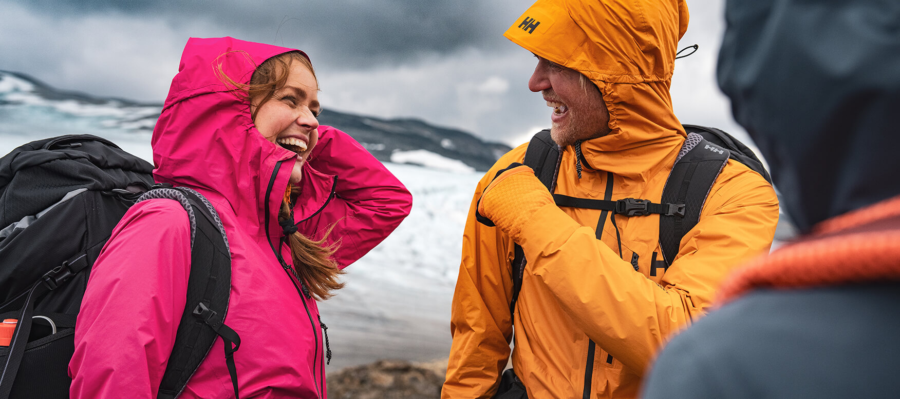Woman and man smiling in the mountains