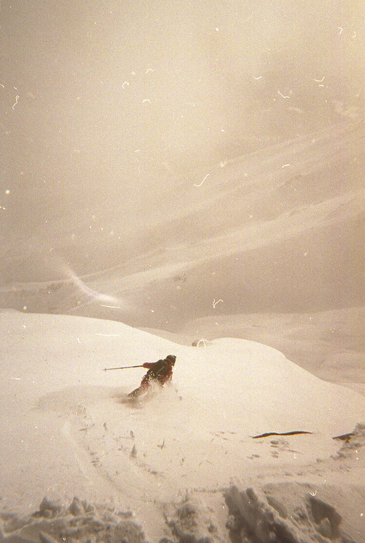 Alpine powder runs off the backside of Furano-dake (1912m) Skier in the backcountry