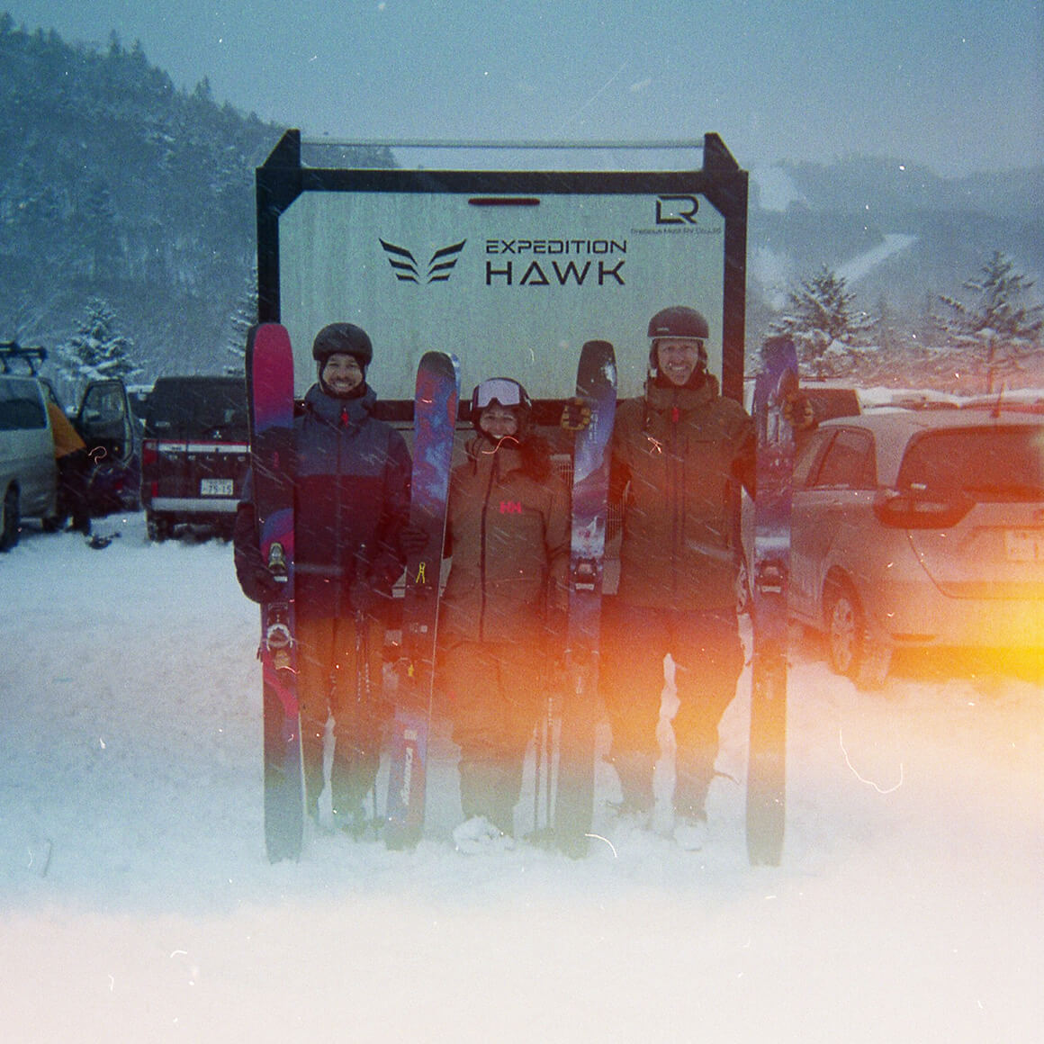 Three skiers, one RV Three skiers, one RV