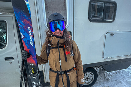 woman posing with skis