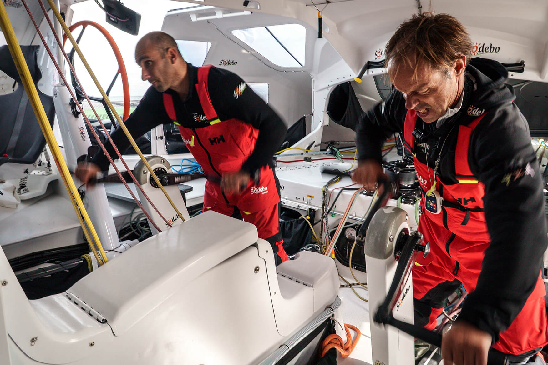 Two sailors grinding below deck.