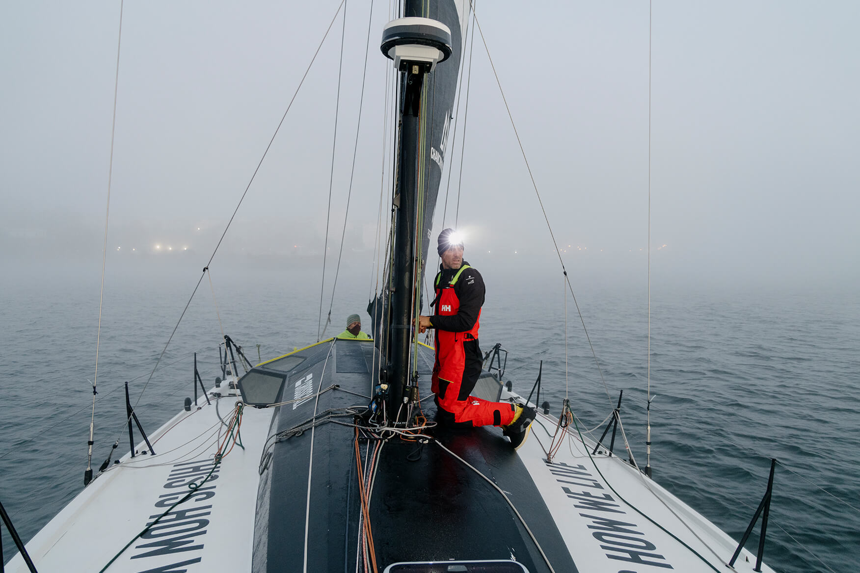 sailor on deck with a headlight