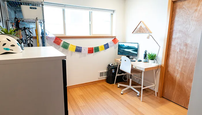 room with a desk and nepalese prayer flags 