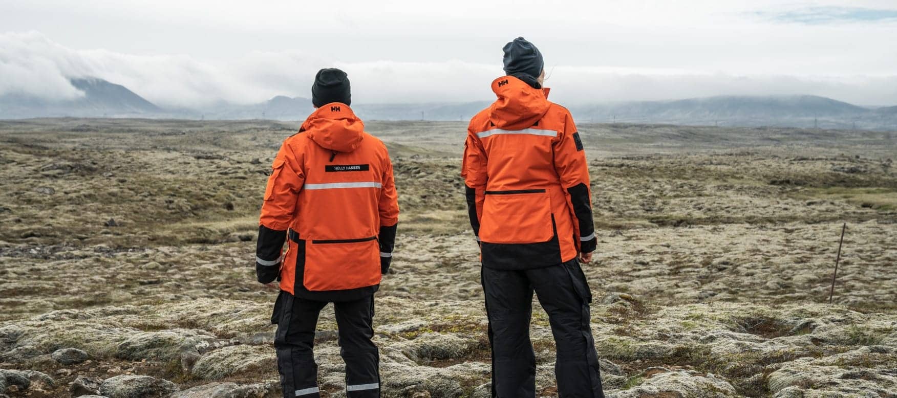 two people stand together looking into the distance wearing the arctic patrol 3 in 1 light parka