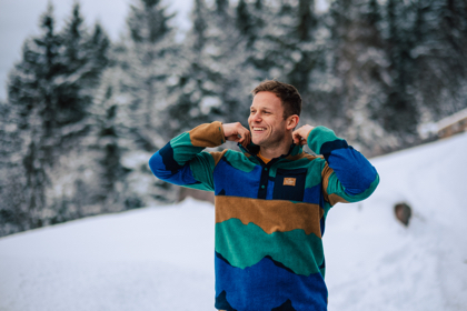 Man wearing a clean fleece in a snowy backdrop.