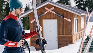 man standing with skis in lifa merino base layer
