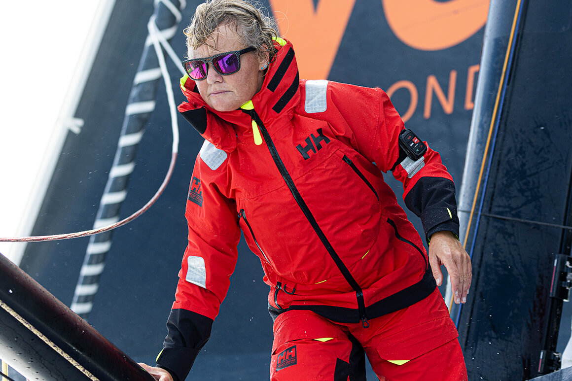 man skiing powder in helly hansen