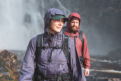 woman and man hiking in the rain