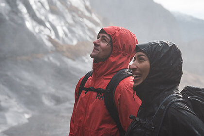 two hikers standing in the rain