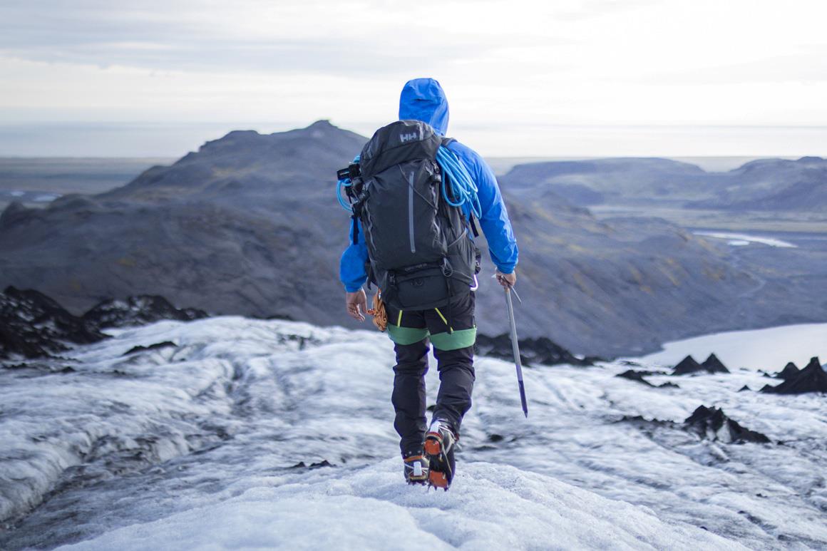 Man hiking in the 65L Capacitator backpack.