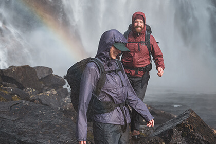 woman and man hiking in the rain