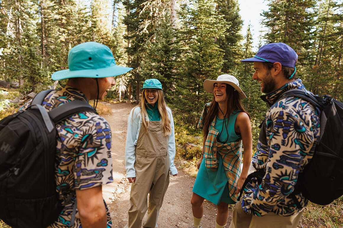 Four people standing in the forest