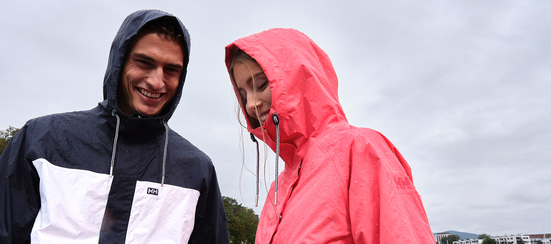 man and woman standing in the rain