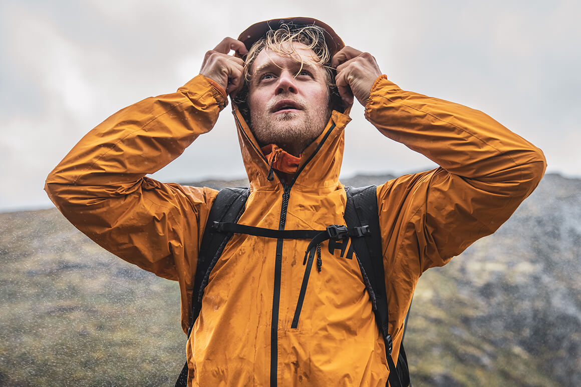 Man standing in the rain in the mountains