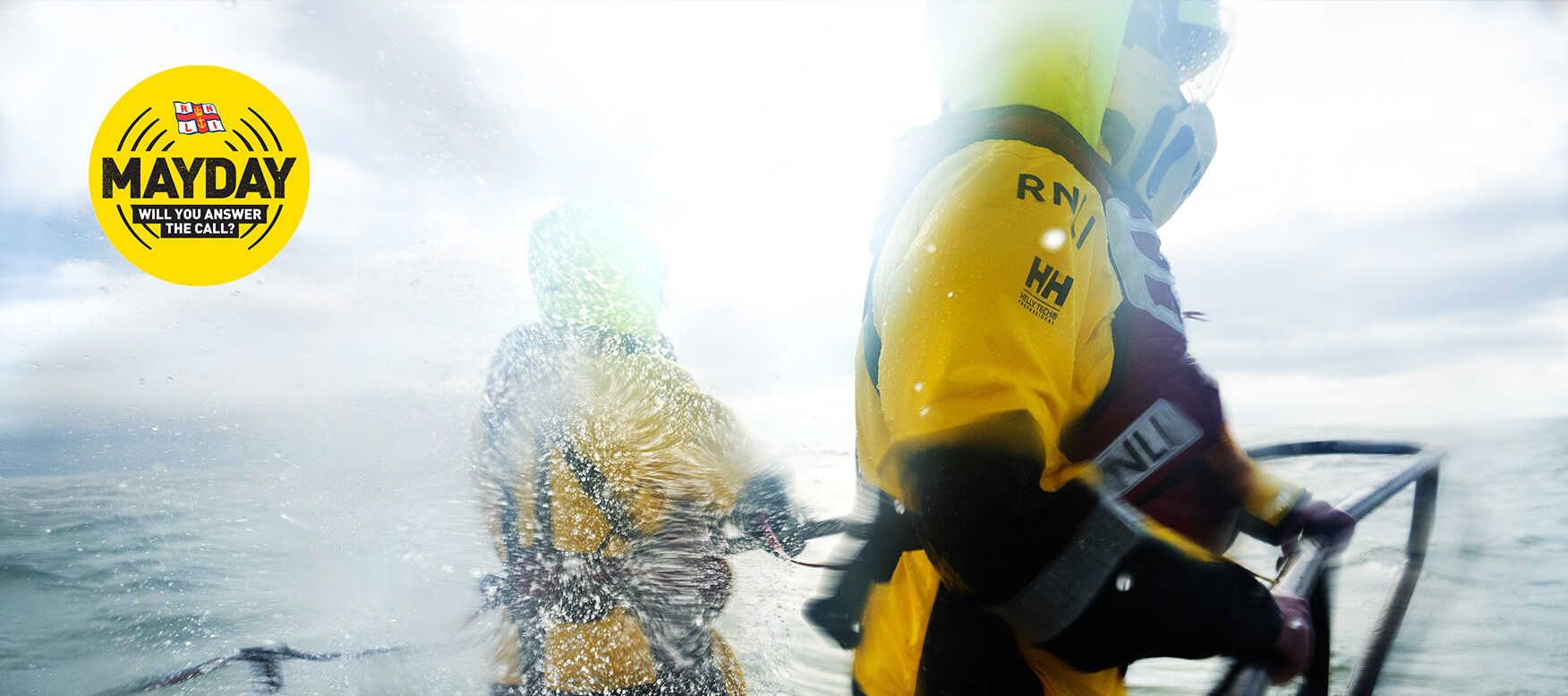 RNLI lifeboat with two crew members on deck