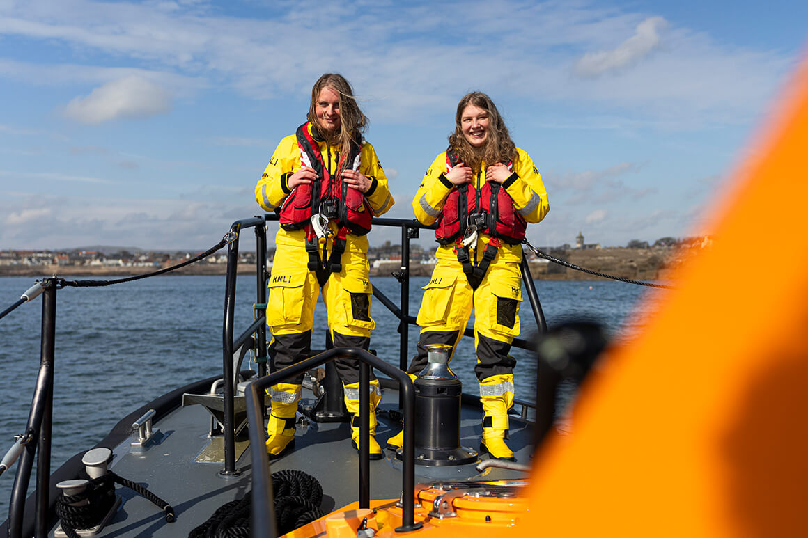 Two RNLI volunteers standing on deck