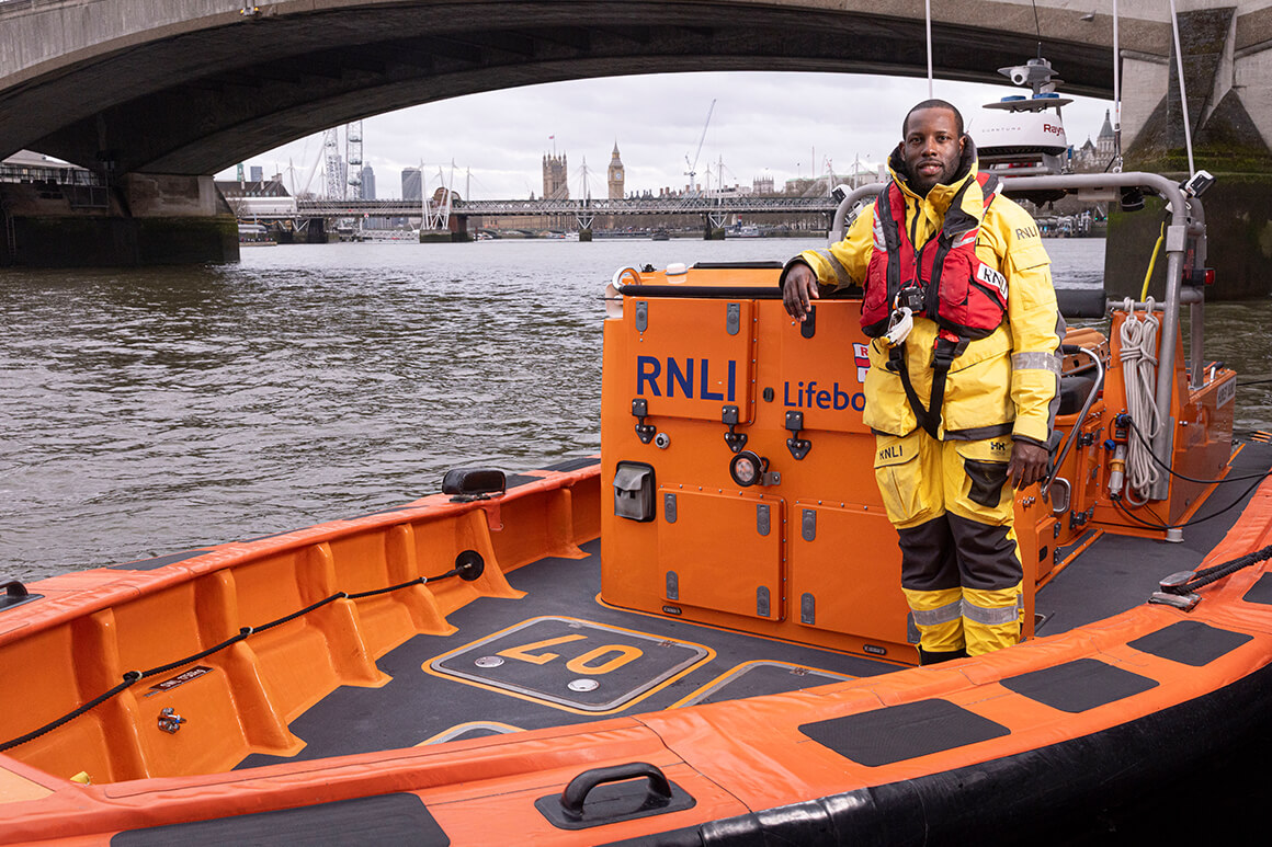 RNLI volunteer standing in a boat