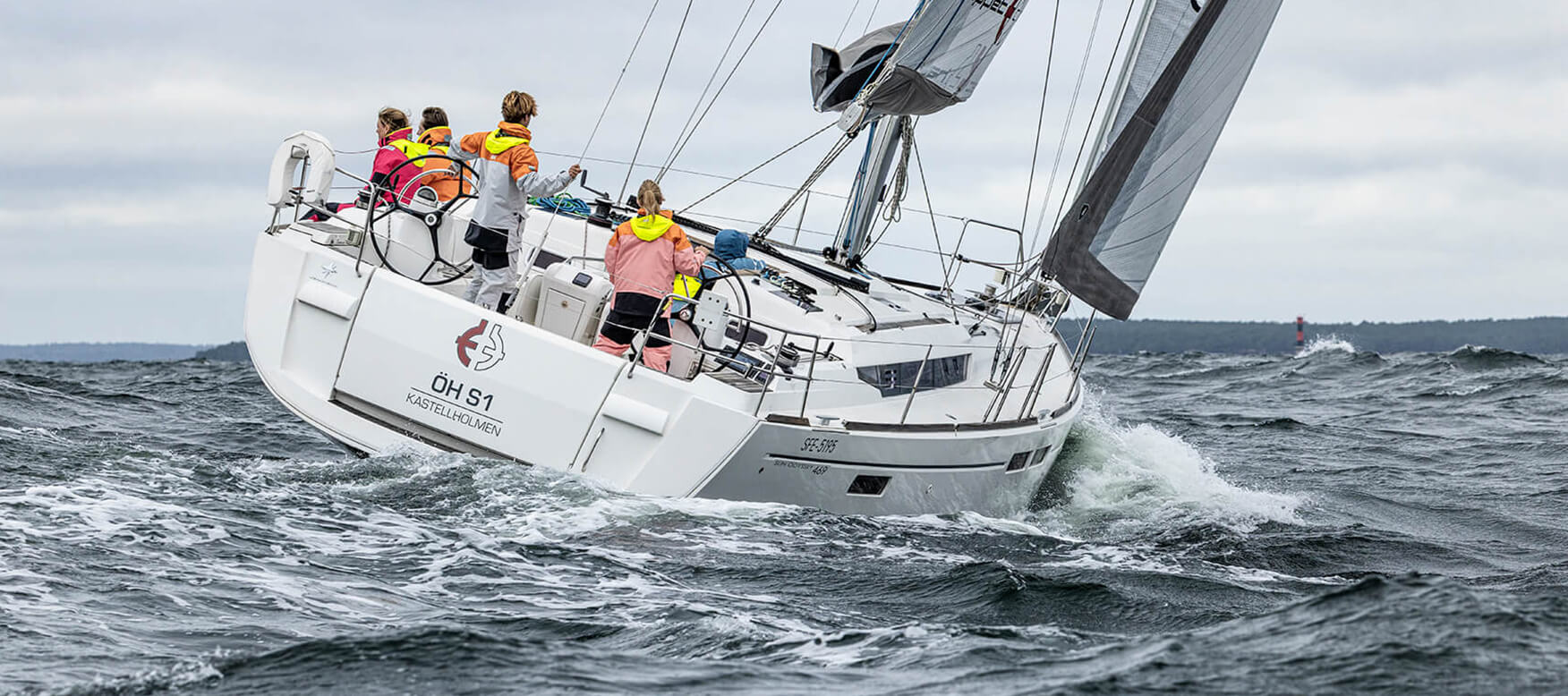 Four people on a sailing boat at sea