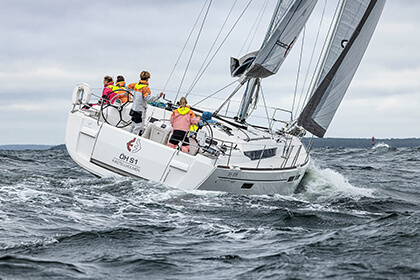 Four people on a sailing boat