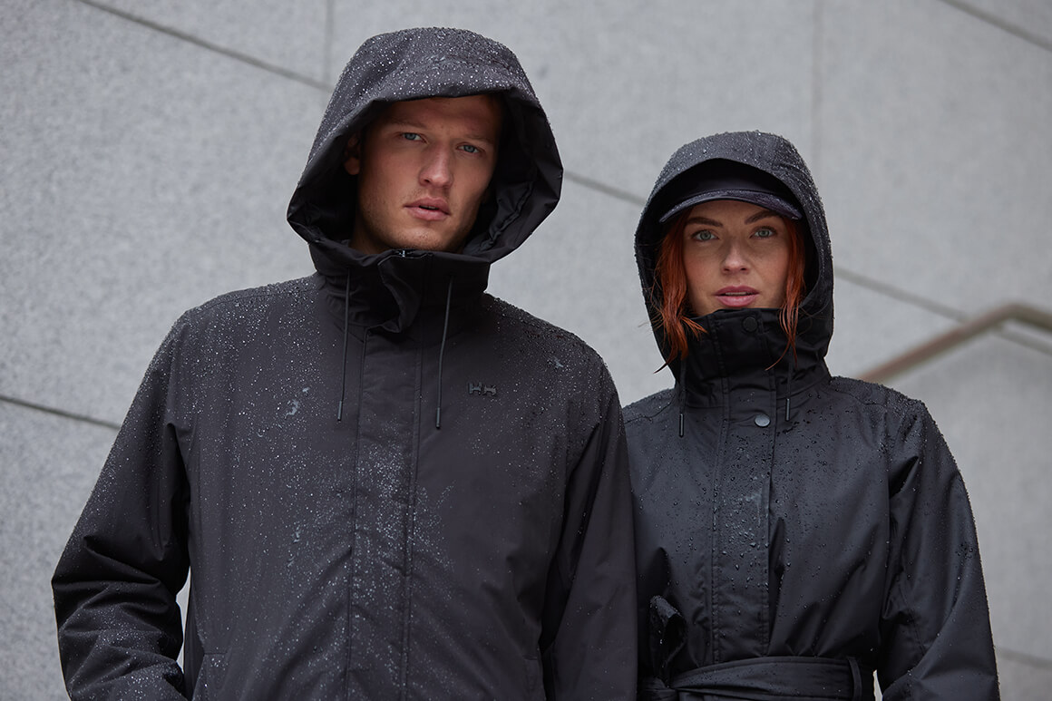 Rain can be unpredictable at the best of times. Don't get caught out—look for a breathable and waterproof construction Mand and woman standing in the rain