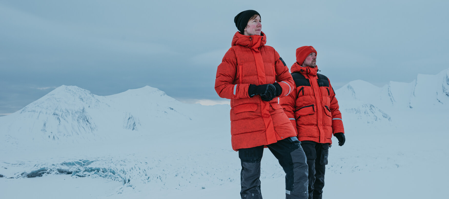 2 people in the snow wearing the arctic patrol jacket
