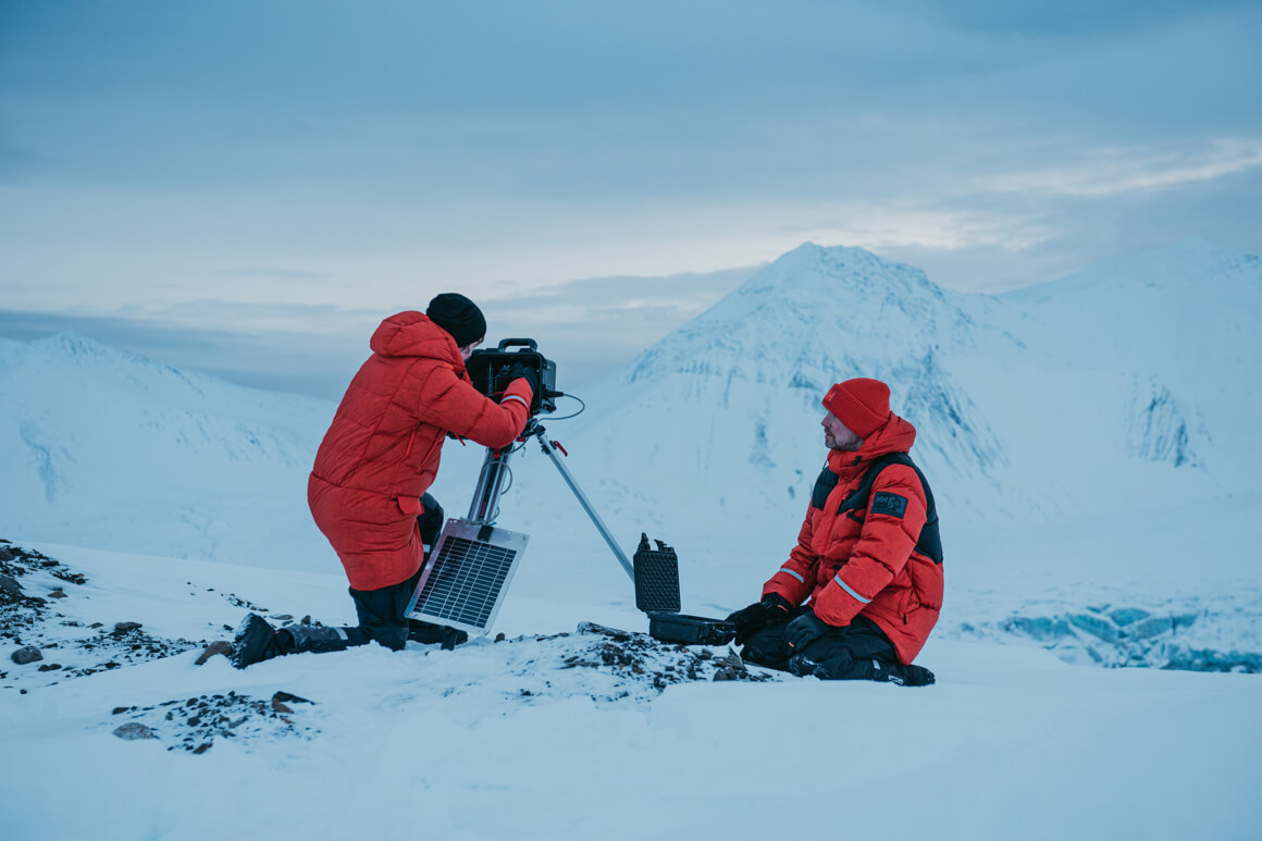2 people in the snow wearing the arctic patrol jacket