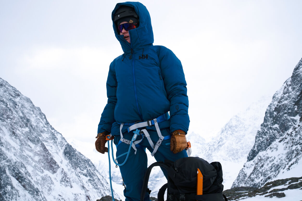 person on the mountain with skiis on their back