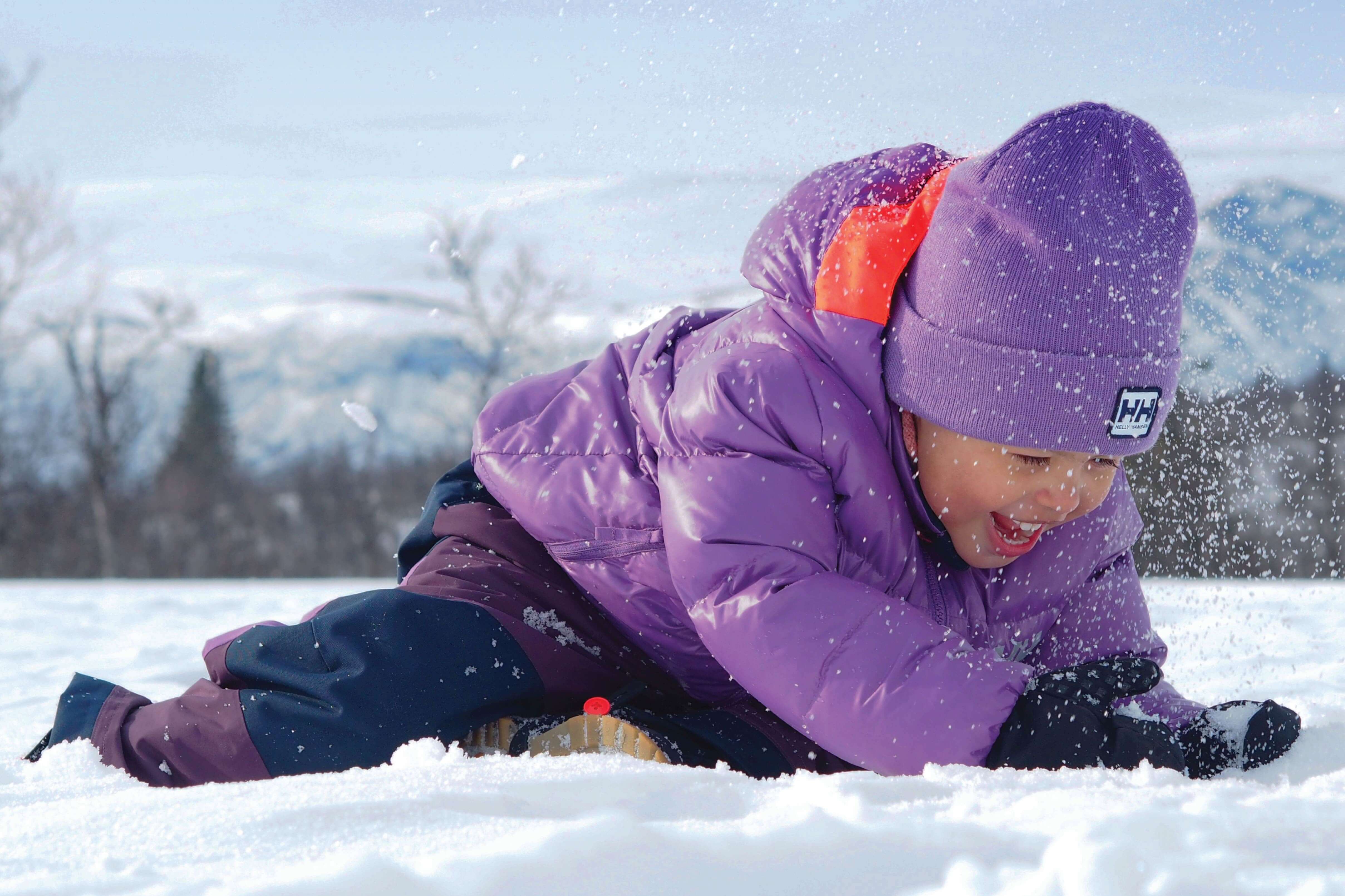 girl playing in the snow