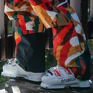 A skier wearing a colorful pair of ski pants.